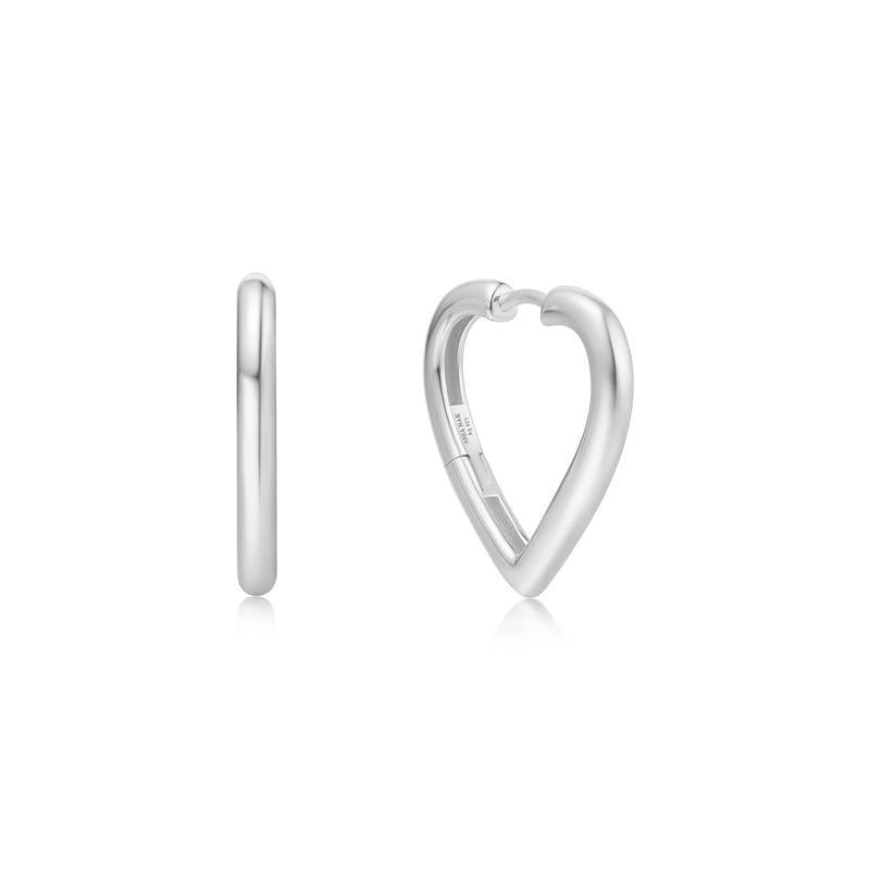 Ania Haie medium heart-shaped hoop earrings in polished sterling silver with a sleek, modern design.