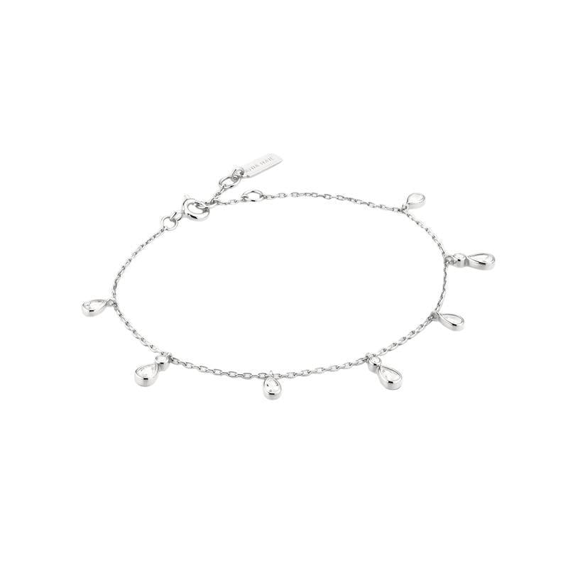 A delicate silver chain anklet featuring seven small teardrop-shaped silver charms, displayed on a clean white background.