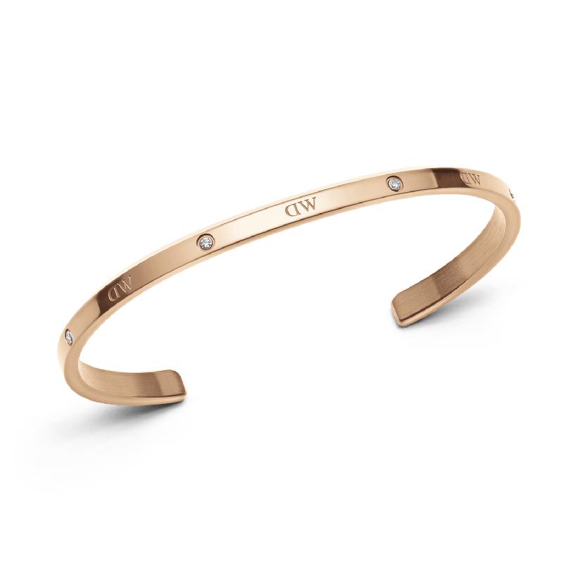 Adjustable rose gold stainless steel cuff bracelet featuring six sparkling crystals and a sleek, minimalist design.