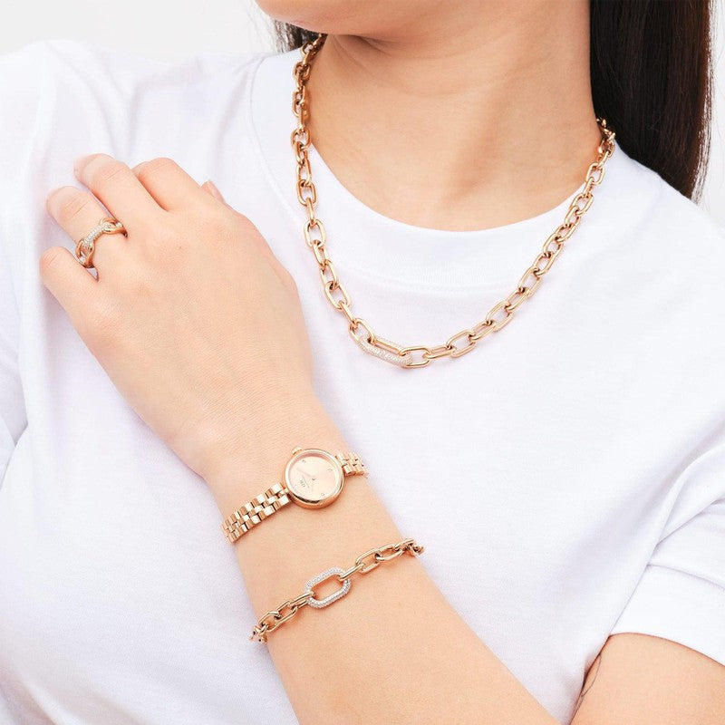 Daniel Wellington rose gold crystal link bracelet paired with a matching watch, necklace, and ring set.
