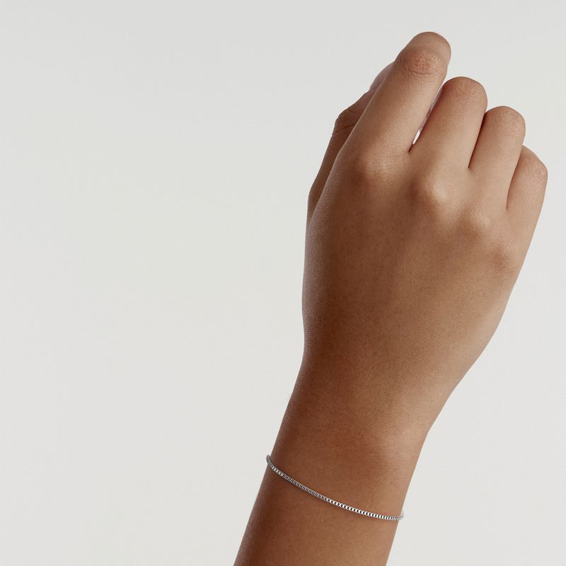 Elegant Daniel Wellington Elan box chain bracelet in polished silver stainless steel worn on a wrist.