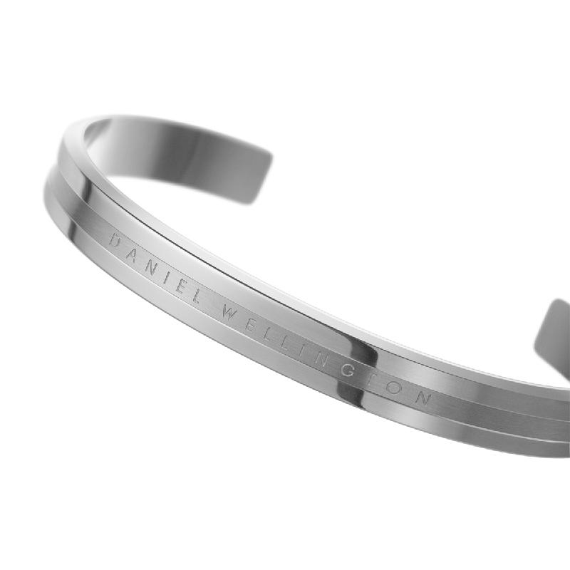 Daniel Wellington Elan silver stainless steel cuff bracelet with engraved logo detail.