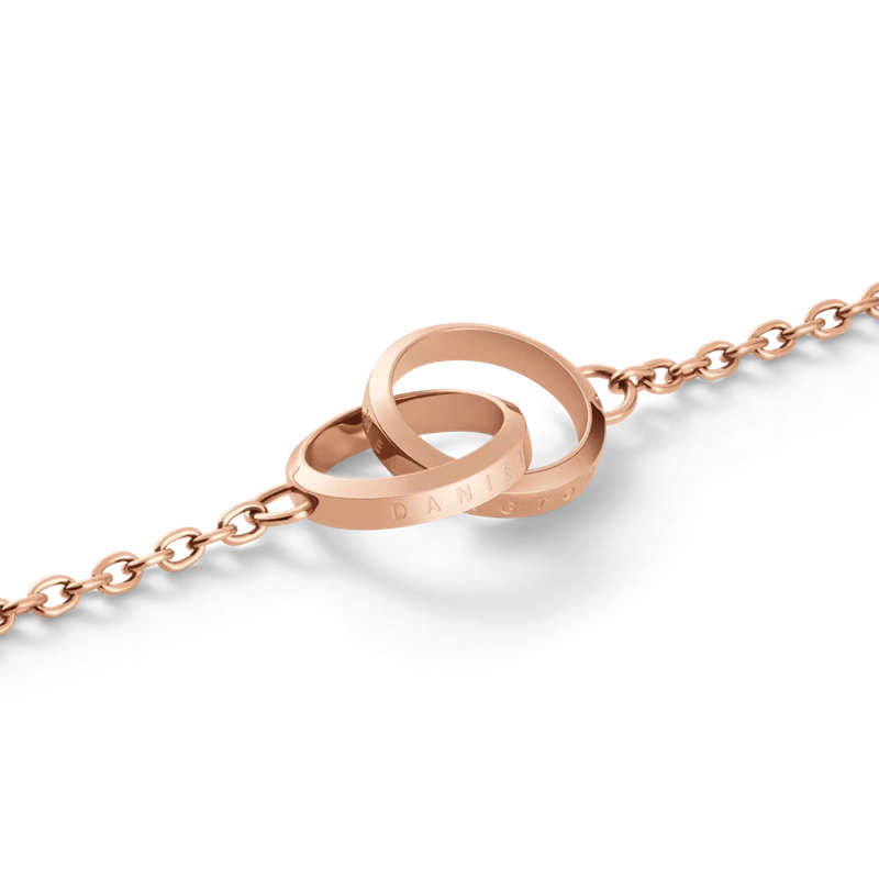 Elegant rose gold Daniel Wellington Elan Unity bracelet featuring two interlocking rings on a delicate stainless steel chain.