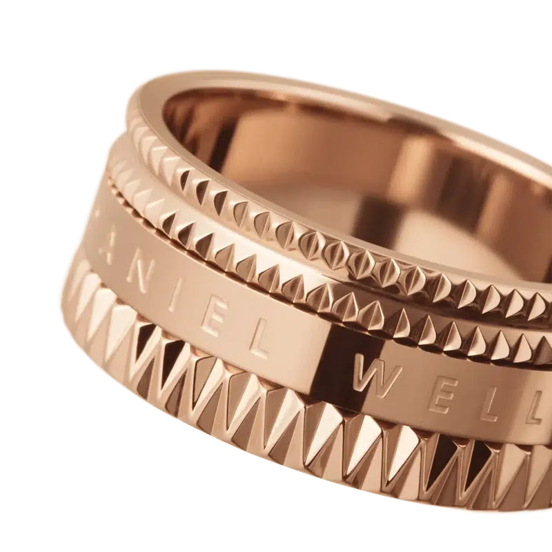 Daniel Wellington Elevation ring in rose gold-plated stainless steel with a geometric, textured design and engraved logo.