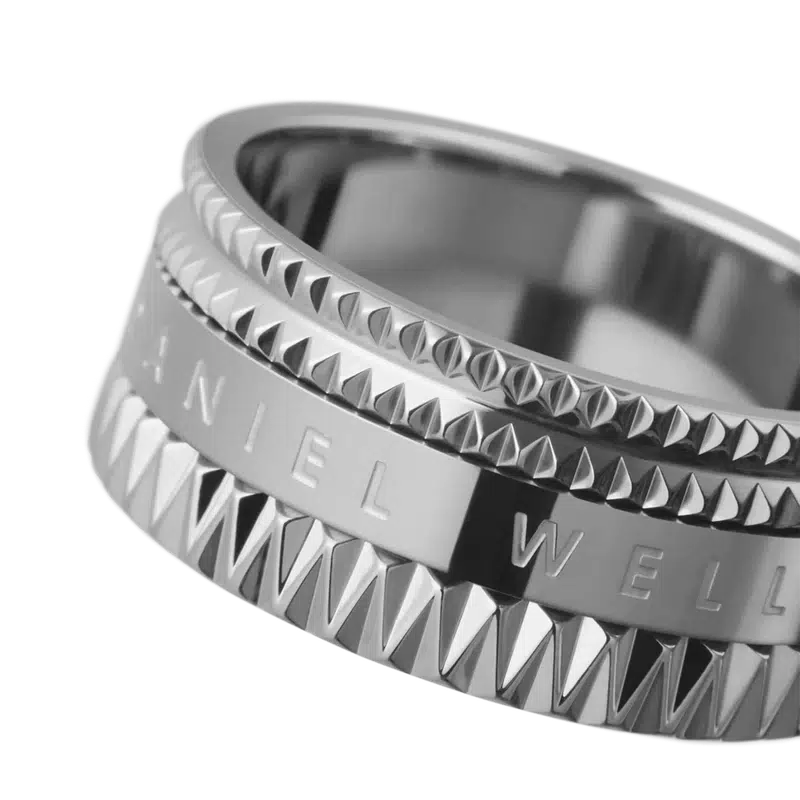 Daniel Wellington Elevation ring in vibrant silver stainless steel with a geometric, textured design and engraved branding.