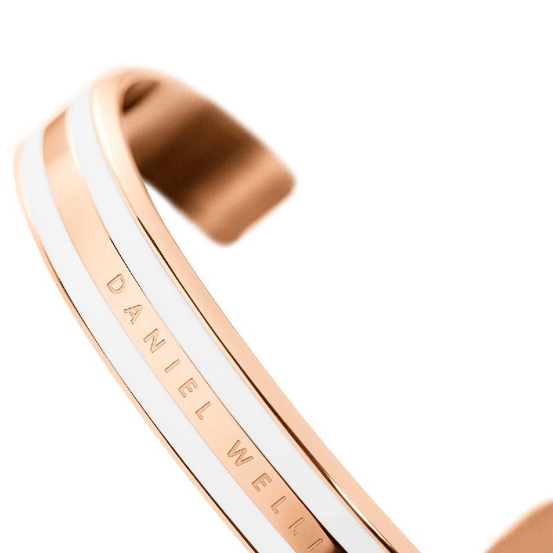 Daniel Wellington Emalie cuff bracelet in rose gold stainless steel with a sleek white enamel inlay and engraved logo.
