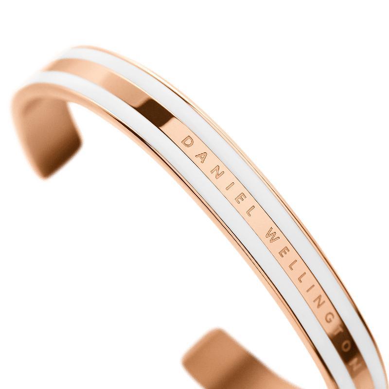 Daniel Wellington Emalie rose gold stainless steel cuff bracelet with a white enamel inlay and engraved logo.
