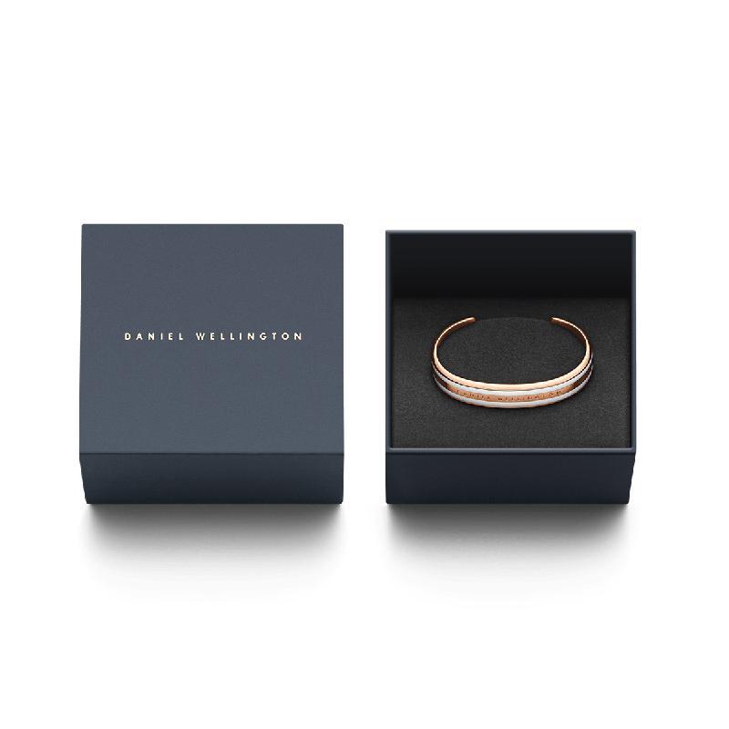 Daniel Wellington Emalie rose gold and white enamel cuff bracelet in a branded gift box.