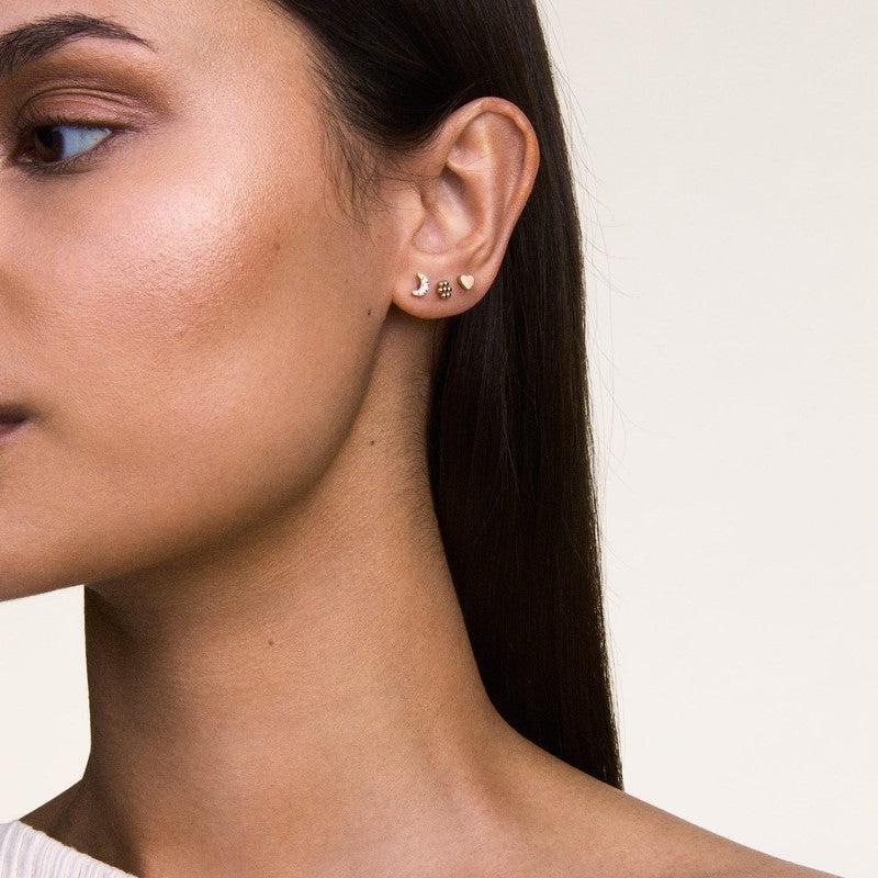 Elegant 3.8mm Daniel Wellington heart stud earring in rose gold-plated stainless steel worn on a model.