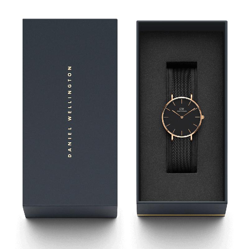 Daniel Wellington Petite Ashfield 32mm watch with black mesh strap and rose gold accents in a branded gift box.