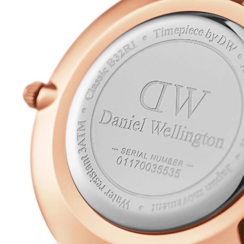 Rose gold Daniel Wellington Petite 32mm watch case back with engraved branding and serial number details.