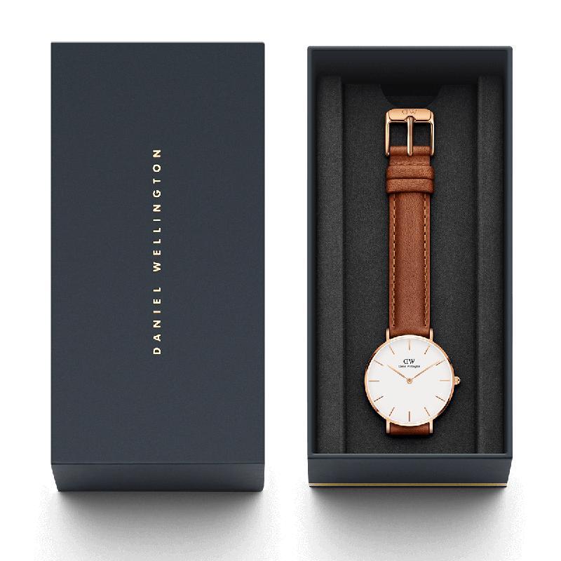 Daniel Wellington Petite 32mm watch with eggshell white dial, rose gold case, and light brown leather Durham strap in box.