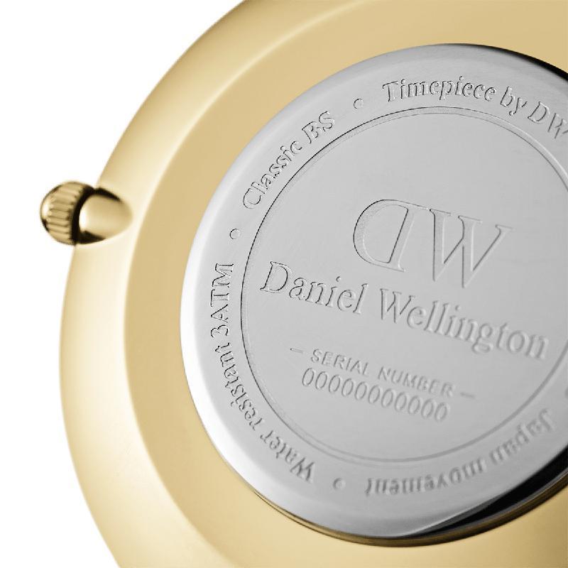 Close-up of the gold stainless steel case back of a Daniel Wellington Petite Evergold 36mm watch with engraved branding.