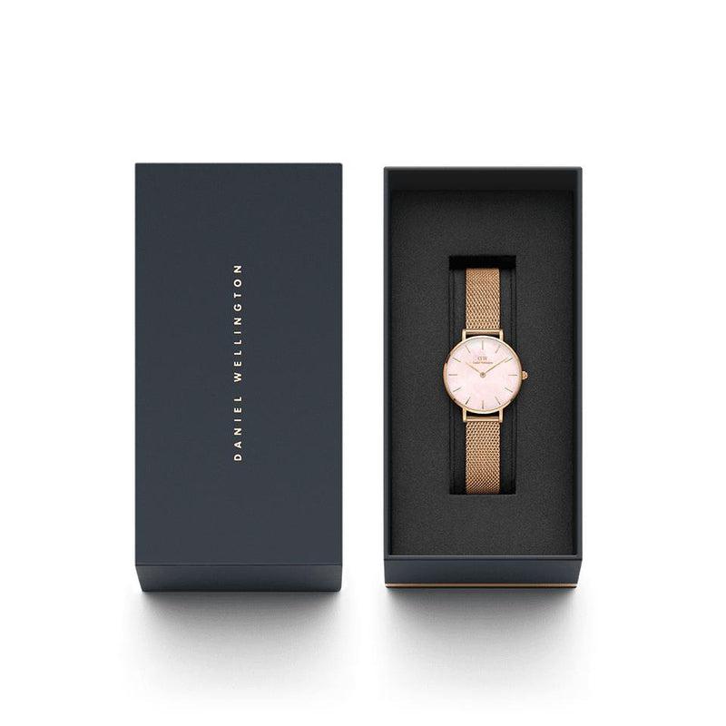 Daniel Wellington 28mm Petite Melrose watch with a pink mother-of-pearl dial and rose gold mesh strap in a gift box.