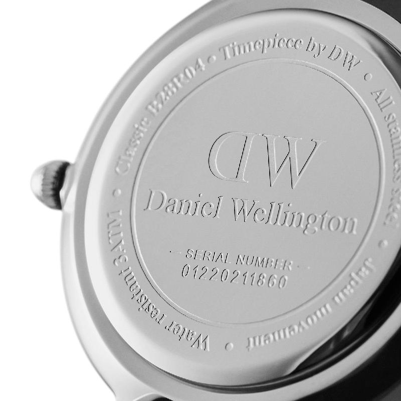 Engraved stainless steel case back of a 28mm Daniel Wellington Petite silver watch.