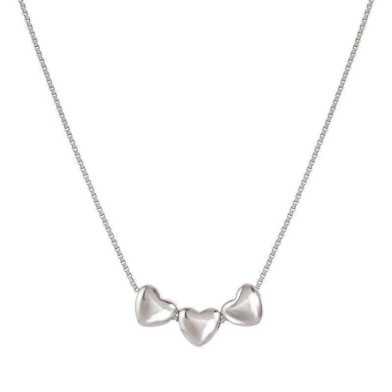 Nomination Armonica necklace in rhodium-plated sterling silver featuring three delicate heart charms on a fine chain.