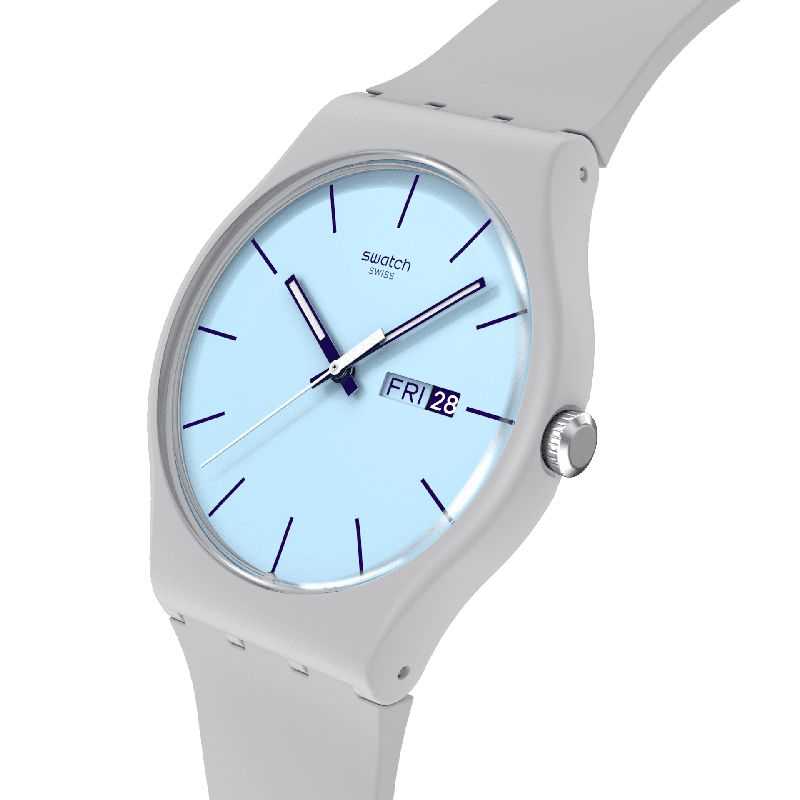 Swatch Blueberry Sky watch featuring a light blue dial, dark purple indexes, and a matte grey biosourced case and strap.