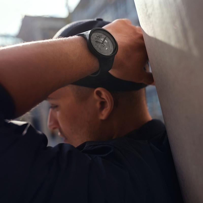 Bold black Swatch C-BLACK watch featuring a 47mm bioceramic case and transparent dial worn on a wrist.