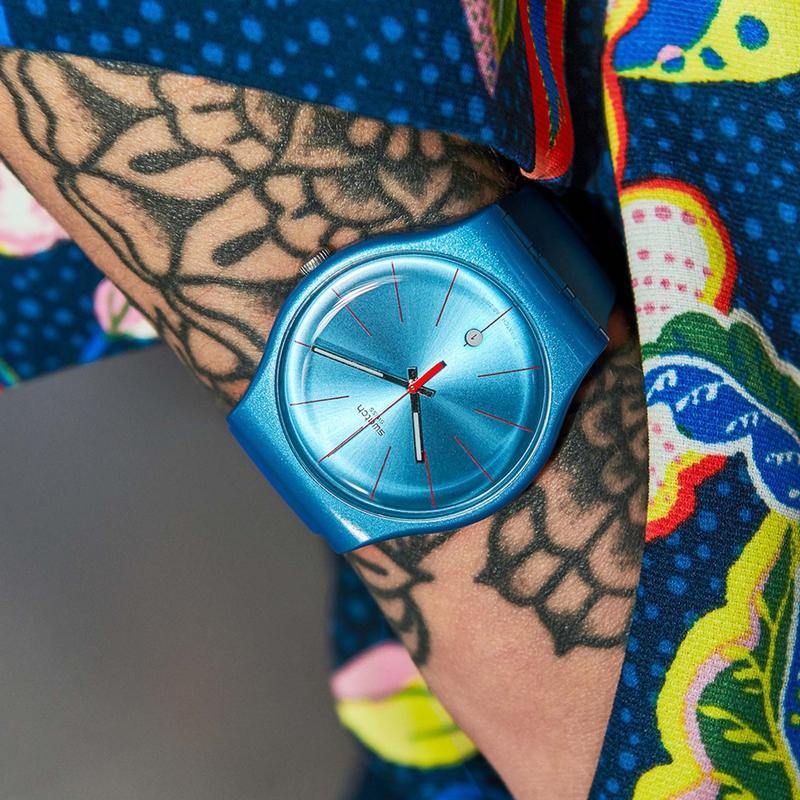 Electric blue Swatch LAGOONAZING watch with a 41mm round case, lustrous silicone strap, and vibrant dial details.