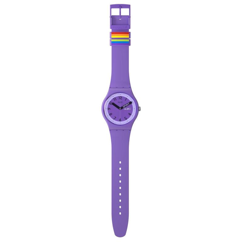 Swatch Proudly Violet biosourced watch with a purple dial, black hands, and rainbow-accented strap loops.