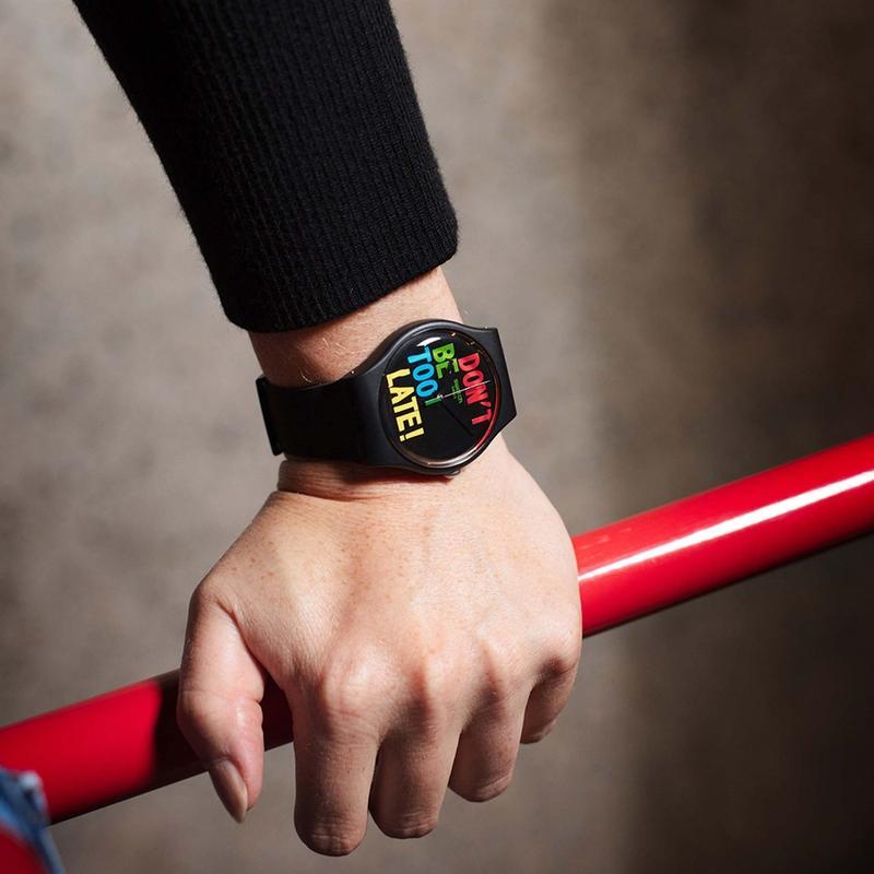 Swatch TIMEFORTIME black bio-sourced watch featuring a bold, colorful Don't Be Too Late dial design on a 41mm round case.