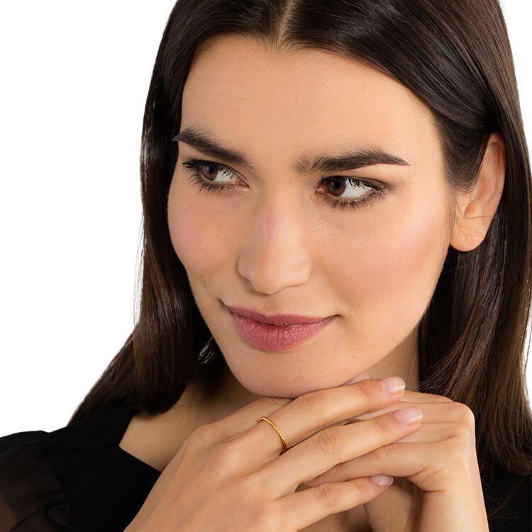 Elegant Thomas Sabo cord ring in 18k yellow gold-plated sterling silver on a woman's finger.