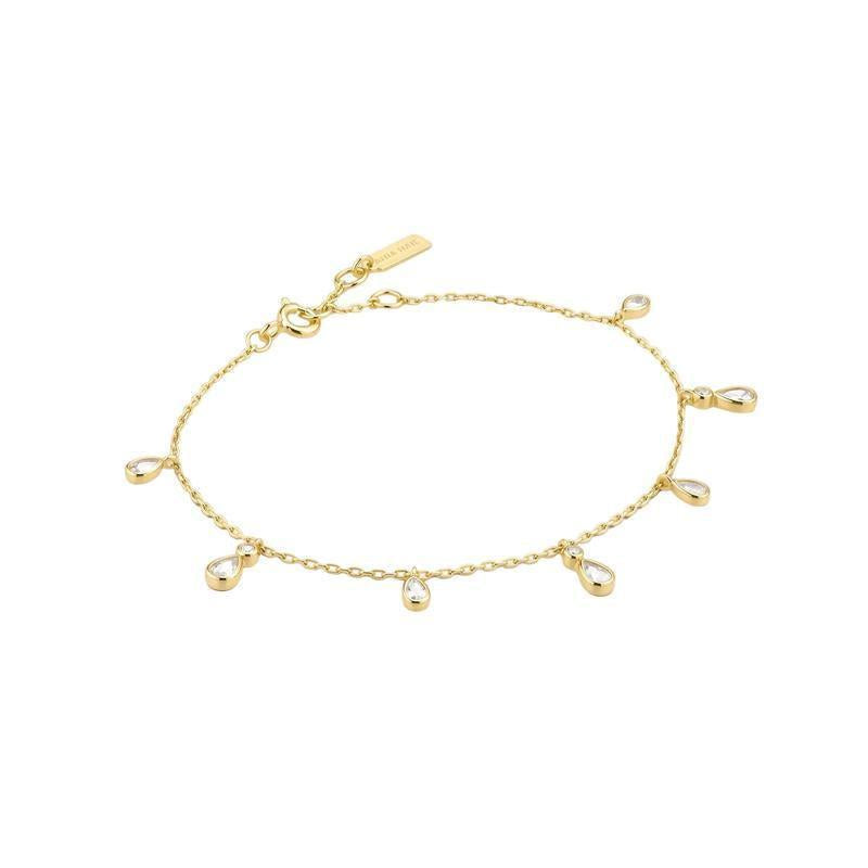 A delicate gold chain bracelet with seven small teardrop-shaped gold charms, displayed on a clean white background.