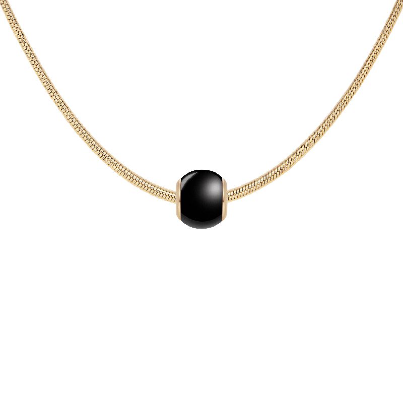 Daniel Wellington gold-plated stainless steel chain necklace featuring a sleek, black ceramic orb charm.
