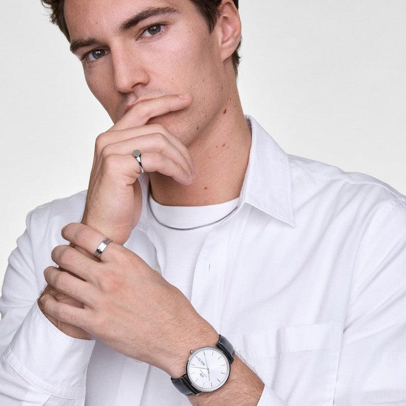 Daniel Wellington Classic Day Display watch with a white dial, silver stainless steel case, and black leather strap.