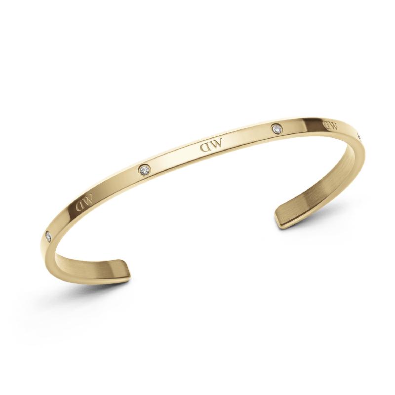 Adjustable gold stainless steel Classic Lumine cuff bangle featuring six sparkling crystals and engraved DW logo.