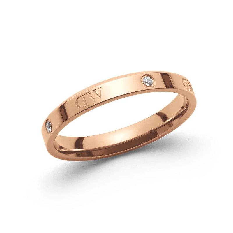 Daniel Wellington Classic Lumine rose gold ring featuring sparkling crystals and engraved logo details in stainless steel.