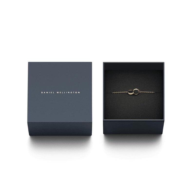 Gold Daniel Wellington Classic Lumine Unity bracelet with crystal-accented intertwined rings in a branded gift box.