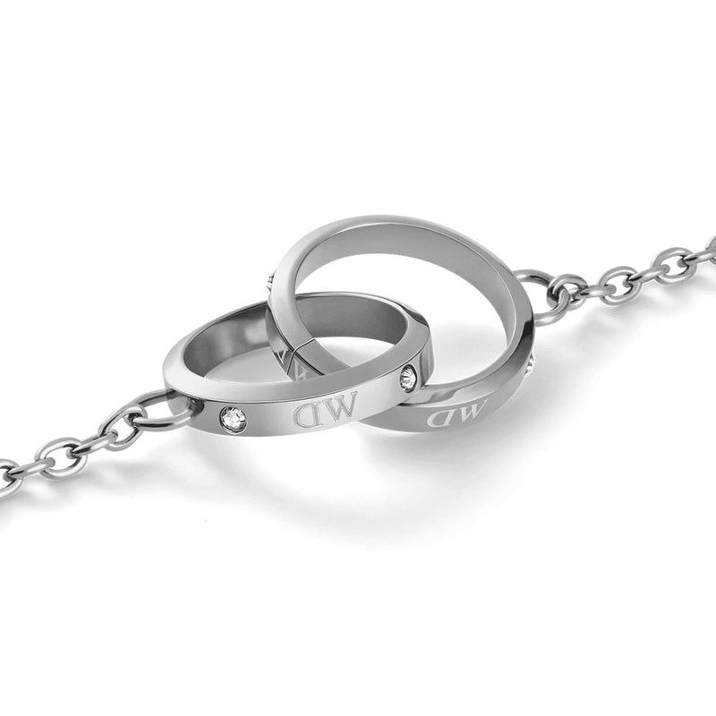 Daniel Wellington silver stainless steel bracelet featuring two intertwined rings with sparkling crystals and engraved logos.