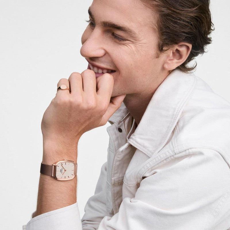 Minimalist rose gold Daniel Wellington Signet Mini ring on a finger, featuring a sleek, polished stainless steel design.