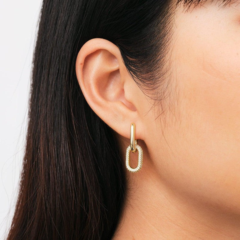 Chunky gold-plated brass link earrings featuring sparkling crystal details in a stylish claw setting.