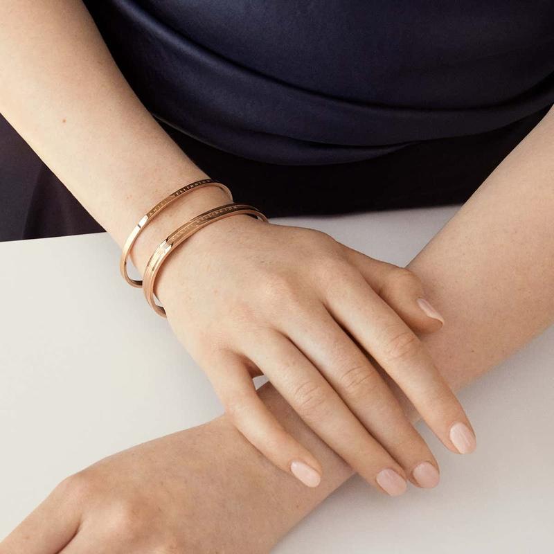 Elegant rose gold Daniel Wellington Elan cuff bangle featuring a minimalist stainless steel design worn on the wrist.