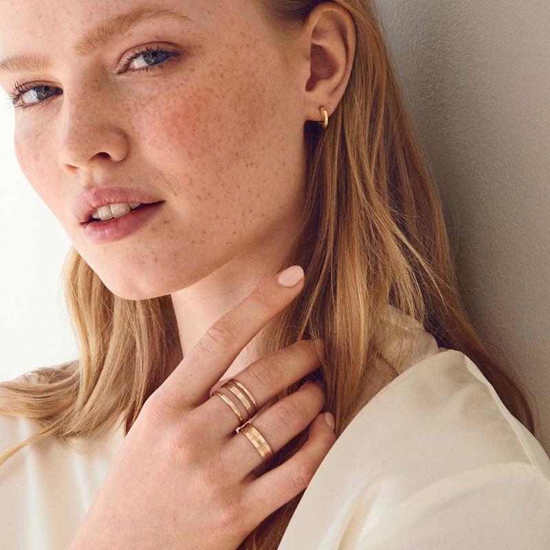 Elegant rose gold-plated stainless steel Elan Triad ring featuring a sophisticated three-band statement design.