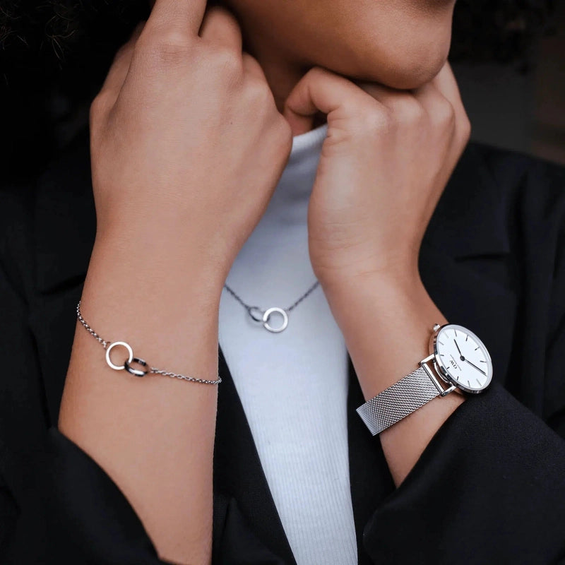 Elegant silver stainless steel Elan Unity bracelet featuring two interlocking rings on a delicate chain.