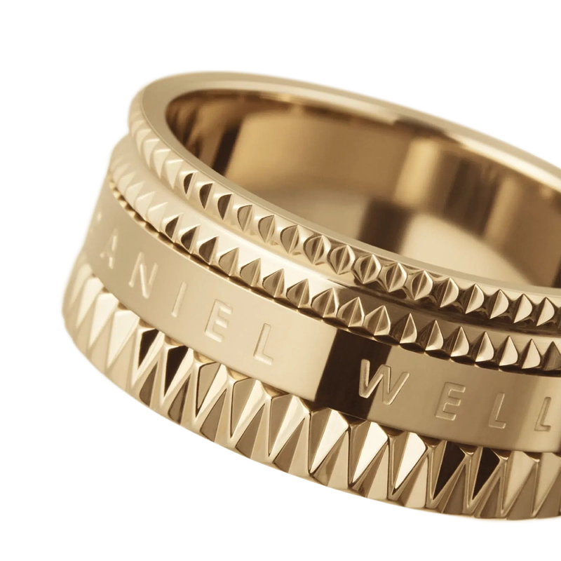 Daniel Wellington Elevation gold-plated stainless steel ring with a geometric, textured design and engraved branding.