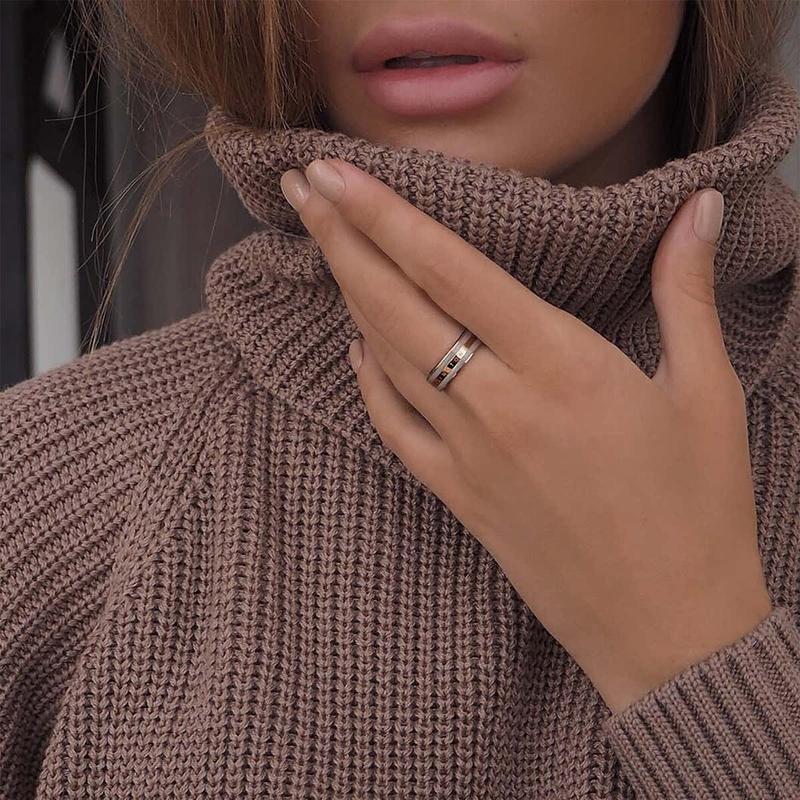 Daniel Wellington Emalie Ring in desert sand enamel and rose gold stainless steel worn on a finger.