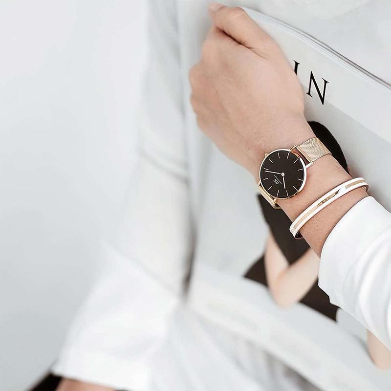 Elegant rose gold Daniel Wellington Emalie Slim cuff bracelet with white enamel detail worn with a matching mesh watch.