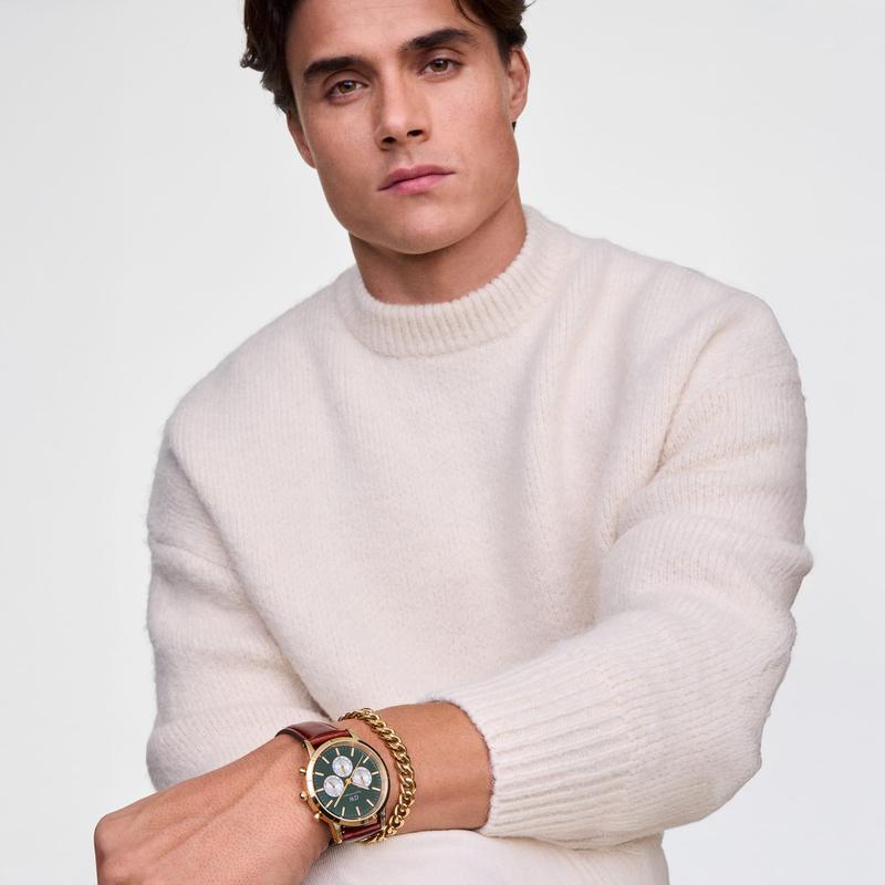 Polished gold-plated stainless steel Ellipse Cuban chain bracelet featuring bold 7mm links on a man's wrist.