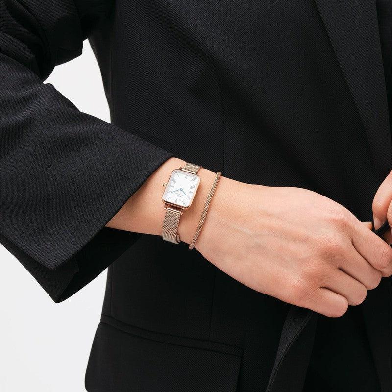 Elegant rose gold stainless steel mesh bracelet paired with a matching Daniel Wellington watch on a wrist.