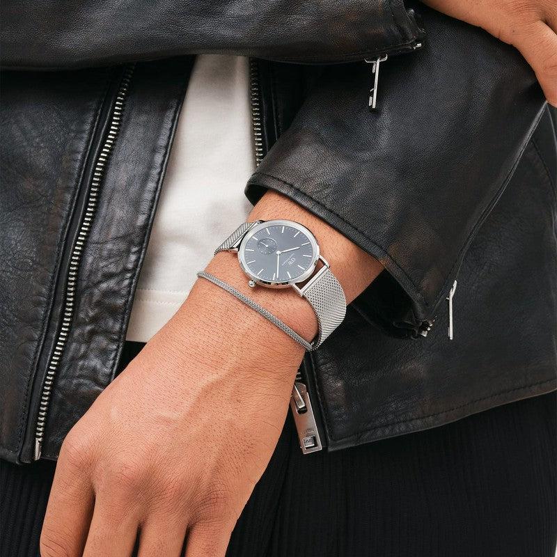 Elegant silver stainless steel mesh bracelet paired with a matching Daniel Wellington watch on a wrist.