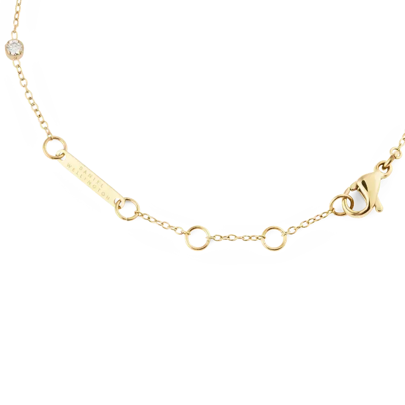 Daniel Wellington gold-toned chain bracelet featuring a branded logo tag and secure lobster clasp closure.