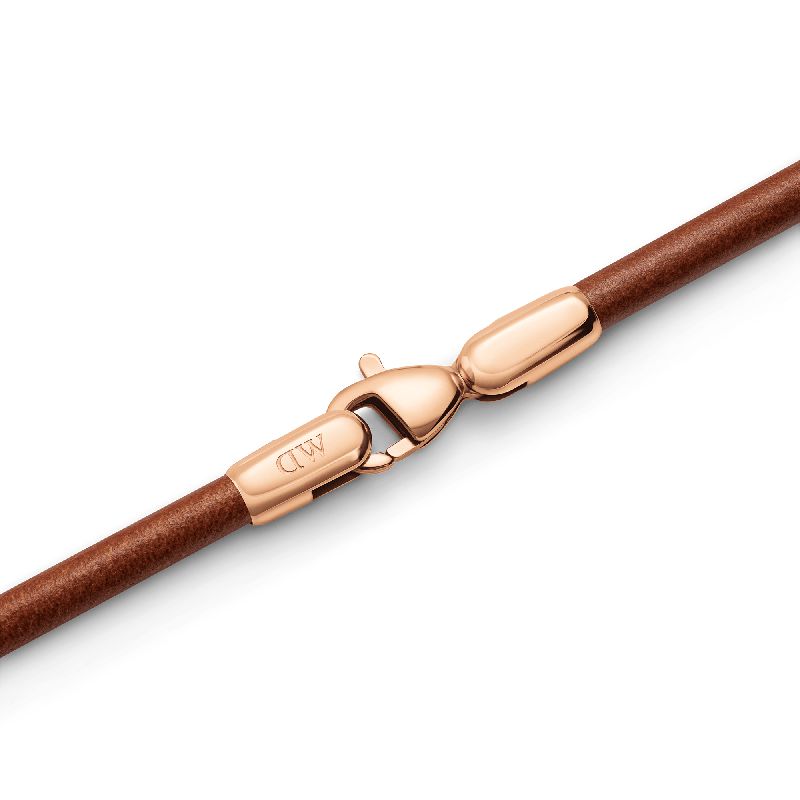 Daniel Wellington St Mawes brown leather bracelet featuring a polished rose gold lobster clasp and signature logo detail.