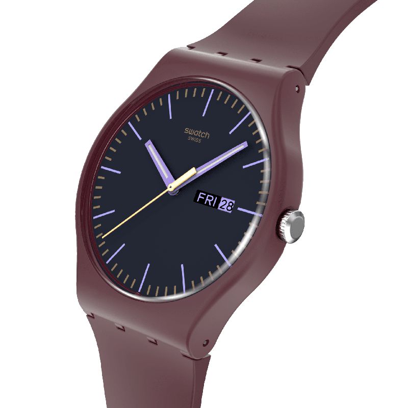 Swatch Burgundy Berry watch with a matte burgundy biosourced case, dark dial, purple indexes, and day-date display.