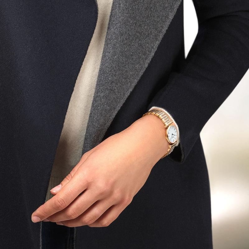 Elegant Longines La Grande Classique watch with a slim 24mm yellow PVD case and white dial worn on a wrist.